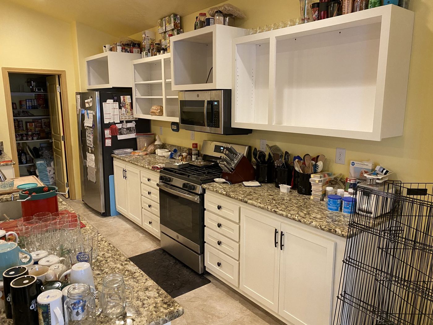 Finished kitchen with white cabinets and granite counters