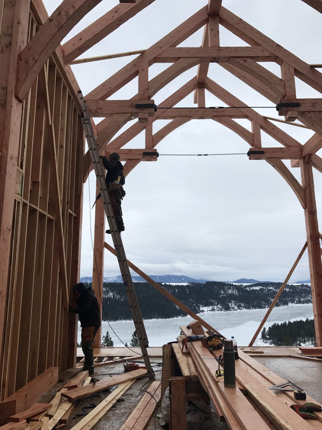 Looking up into a timber frame against open sky